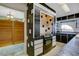 View of kitchen with black and white tile, stove and access to laundry room at 2711 W Marion Ave, Punta Gorda, FL 33950