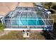 Enclosed rectangular pool with gray stone deck at 2711 W Marion Ave, Punta Gorda, FL 33950