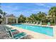 Community pool with lounge chairs and a shaded seating area at 341 Cape Harbour Loop # 108, Bradenton, FL 34212