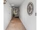 Long hallway with light-colored walls and decorative accents at 3761 Somerville Dr # 1518, Sarasota, FL 34232