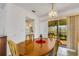 Dining room with wooden table, chandelier, and view to backyard at 4206 Chinaberry Rd, Bradenton, FL 34208