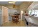 Galley style kitchen with white cabinets and breakfast bar at 4805 61St Avenue W Ter, Bradenton, FL 34210