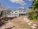 Landscaped backyard with a pathway leading to a screened pool area at 4865 Featherbed Ln, Sarasota, FL 34242