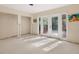 A bedroom with new carpet and French doors leading outside at 4865 Featherbed Ln, Sarasota, FL 34242