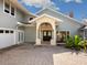 Inviting front entrance with a stone archway and double doors at 4865 Featherbed Ln, Sarasota, FL 34242