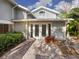 House exterior showcasing a white door and brick patio at 4865 Featherbed Ln, Sarasota, FL 34242