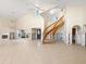 High-ceilinged living room with spiral staircase and tiled floor; currently under renovation at 4865 Featherbed Ln, Sarasota, FL 34242