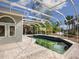 Pool and patio area with screened enclosure, overlooking the backyard at 4865 Featherbed Ln, Sarasota, FL 34242