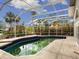 Inviting pool area with screened enclosure, ready for your personal touch at 4865 Featherbed Ln, Sarasota, FL 34242