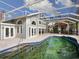 Spacious pool and patio area with screened enclosure and house view at 4865 Featherbed Ln, Sarasota, FL 34242
