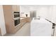 Modern kitchen with island and stainless steel appliances at 4950 Remington Dr # 407, Sarasota, FL 34234