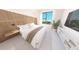 Spacious bedroom with large window and wood accent wall at 4950 Remington Dr # 407, Sarasota, FL 34234