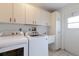 Laundry room with washer, dryer, cabinets, and utility sink at 5502 Garden Lakes Oak, Bradenton, FL 34203