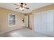 Bright bedroom with ceiling fan, window, and built-in closet at 5502 Garden Lakes Oak, Bradenton, FL 34203