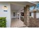 Covered entryway with brick columns and tile flooring at 5502 Garden Lakes Oak, Bradenton, FL 34203