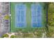 Two tennis courts with green surface from above at 5502 Garden Lakes Oak, Bradenton, FL 34203