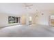 Living room with large window, wet bar and carpet at 5502 Garden Lakes Oak, Bradenton, FL 34203