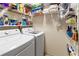 Laundry room with washer, dryer, and shelving at 6016 28Th W St # 6016, Bradenton, FL 34207
