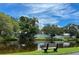 Serene view of a canal with a park bench under a blue sky at 6016 28Th W St # 6016, Bradenton, FL 34207