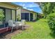 Small patio with table and chairs and view of the backyard at 6016 28Th W St # 6016, Bradenton, FL 34207