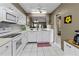 White kitchen with breakfast bar and view to living room at 6016 28Th W St # 6016, Bradenton, FL 34207