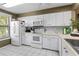 White kitchen with ample cabinet space and appliances at 6016 28Th W St # 6016, Bradenton, FL 34207