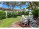 Small patio with table and chairs, and view of backyard at 6016 28Th W St # 6016, Bradenton, FL 34207