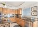 Kitchen with light wood cabinets, granite counters, and stainless steel appliances at 8142 Misty Oaks Blvd, Sarasota, FL 34243