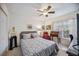 Bedroom with a queen-size bed, ceiling fan, and workspace at 818 Wexford Blvd # 818, Venice, FL 34293