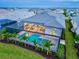 Aerial view of a luxurious home featuring a screened pool, jacuzzi, and manicured landscaping at 8332 Sea Glass Ct, Sarasota, FL 34240