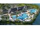 Aerial view of a luxurious community pool area with palm trees, lounge chairs, and inviting blue pools at 8332 Sea Glass Ct, Sarasota, FL 34240