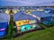 Stunning aerial view of a home with a screened pool area, tropical landscaping, and serene neighborhood setting at 8332 Sea Glass Ct, Sarasota, FL 34240