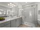 Modern bathroom featuring a large frameless glass shower, dual sinks and quartz counters at 8332 Sea Glass Ct, Sarasota, FL 34240