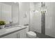 Modern bathroom featuring a glass enclosed shower with decor, tile accents, and gray quartz countertops at 8332 Sea Glass Ct, Sarasota, FL 34240