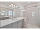 Elegant bathroom featuring a soaking tub, walk-in shower, and double vanity at 8332 Sea Glass Ct, Sarasota, FL 34240