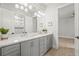 Bathroom with a double vanity, bright lighting, and decor with tile flooring and an open shower at 8332 Sea Glass Ct, Sarasota, FL 34240