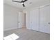 Bright bedroom featuring a ceiling fan, tiled floors, and a large closet with sliding doors at 8332 Sea Glass Ct, Sarasota, FL 34240