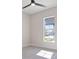 Bright bedroom featuring modern lighting, an awning window, and light hardwood floors at 8332 Sea Glass Ct, Sarasota, FL 34240