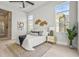Bright bedroom featuring neutral tones, a ceiling fan, light hardwood floors, and a decorative area rug at 8332 Sea Glass Ct, Sarasota, FL 34240