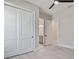 Bedroom with hardwood flooring, modern ceiling fan, and closet, flowing into the en suite bathroom at 8332 Sea Glass Ct, Sarasota, FL 34240