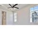 Bedroom with large windows and ceiling fan at 8332 Sea Glass Ct, Sarasota, FL 34240