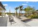 A welcoming community area with chairs, tables, palm trees, and lush landscaping for residents to relax and socialize at 8332 Sea Glass Ct, Sarasota, FL 34240