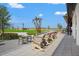 An inviting outdoor community space with comfortable rocking chairs, tables, and a serene view of green space at 8332 Sea Glass Ct, Sarasota, FL 34240