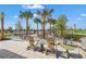 Outdoor lounge area featuring comfortable seating, tables, and scenic views of palm trees and lush landscaping at 8332 Sea Glass Ct, Sarasota, FL 34240