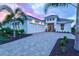 Beautifully designed home featuring a three-car garage, paver driveway, and meticulously maintained landscaping at 8332 Sea Glass Ct, Sarasota, FL 34240