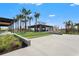 Community clubhouse featuring covered patio, landscaping, and concrete parking pad at 8332 Sea Glass Ct, Sarasota, FL 34240