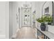 Bright foyer with decorative lighting, stylish decor, and glass paneled doors to a welcoming interior at 8332 Sea Glass Ct, Sarasota, FL 34240