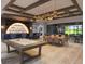 A modern game room with a pool table, bar, and seating areas, perfect for entertaining friends and Gathering at 8332 Sea Glass Ct, Sarasota, FL 34240