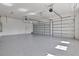 Spacious three-car garage featuring clean epoxy flooring and ample room for parking and storage at 8332 Sea Glass Ct, Sarasota, FL 34240