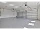 This is a spacious garage with epoxy flooring, three garage doors and an interior entry door at 8332 Sea Glass Ct, Sarasota, FL 34240